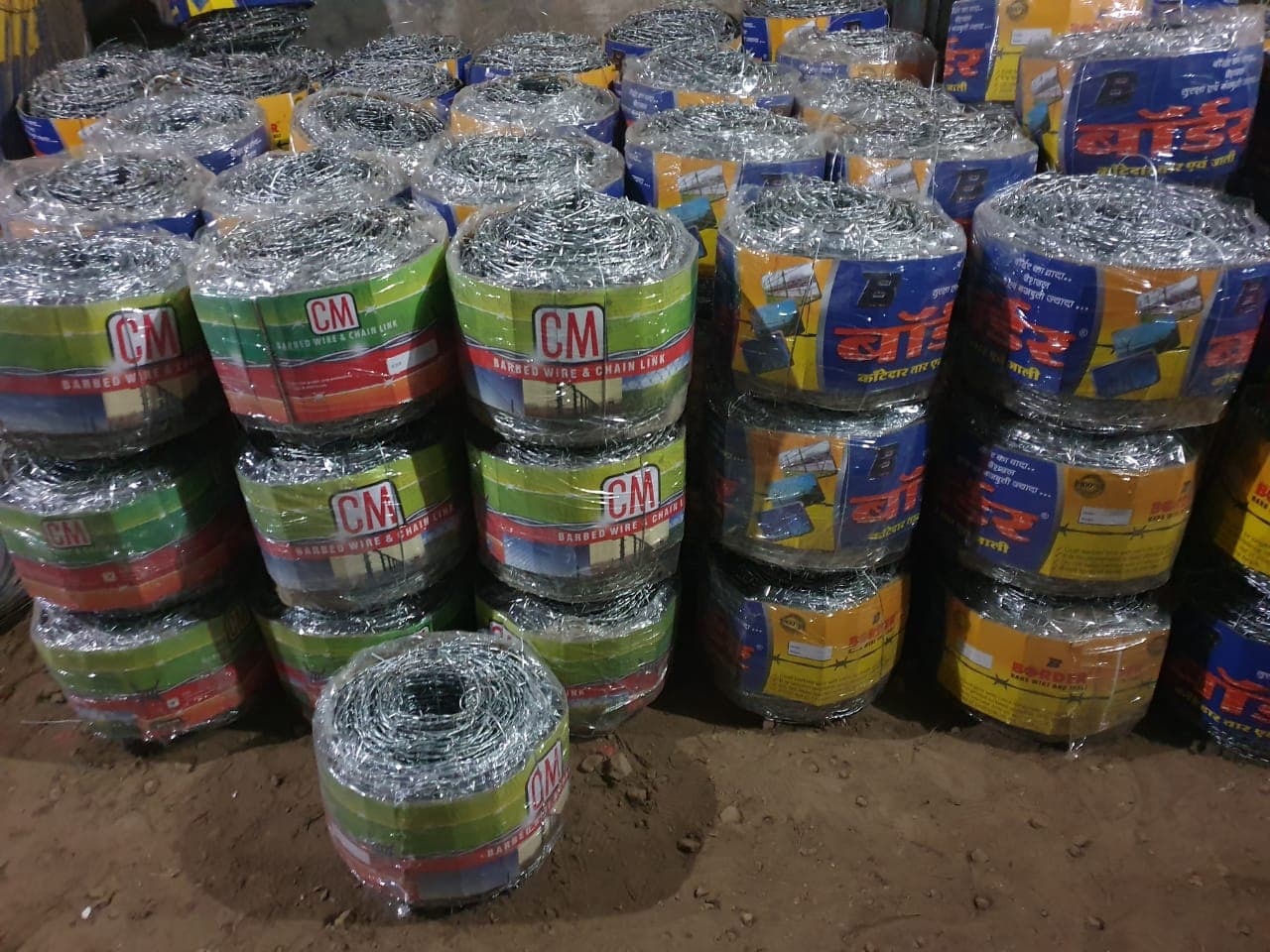 CM and Border barbed wire and chain link coils in warehouse