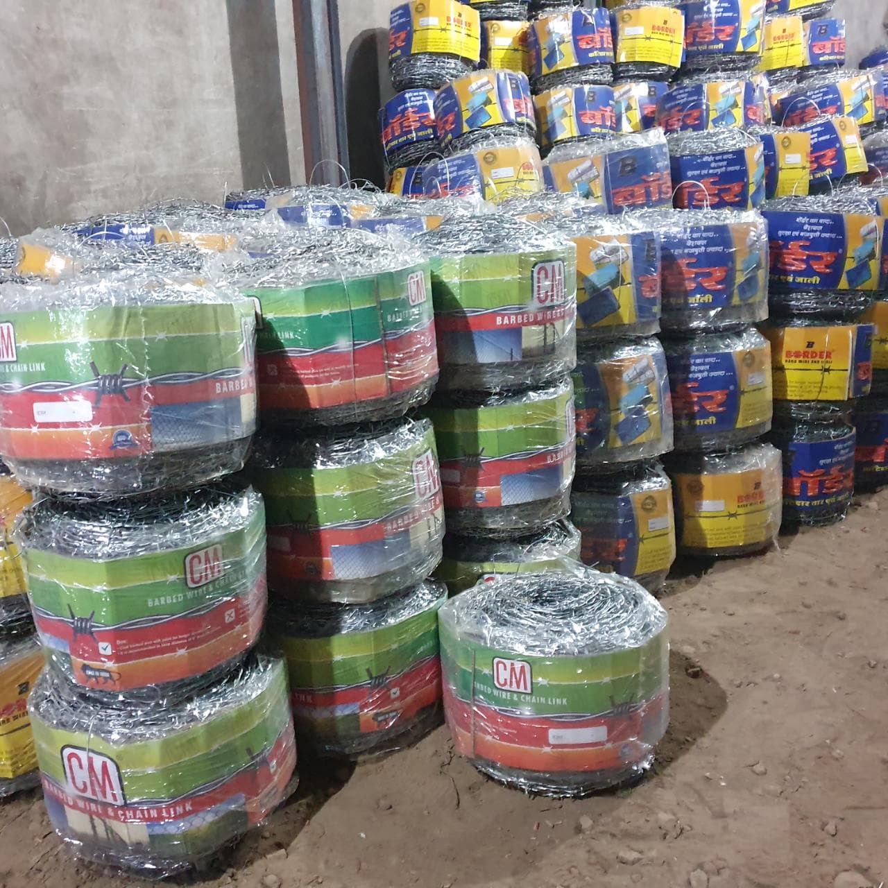 Barbed wire rolls — CM and Border brand stock at warehouse