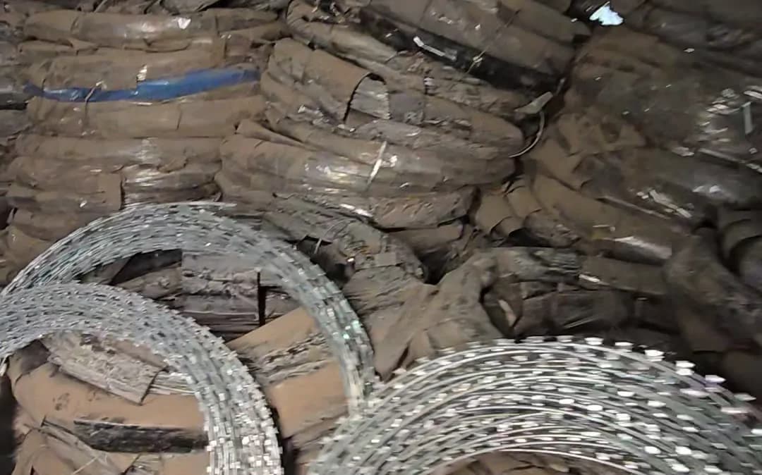 Coils of barbed wire stacked for boundary fencing