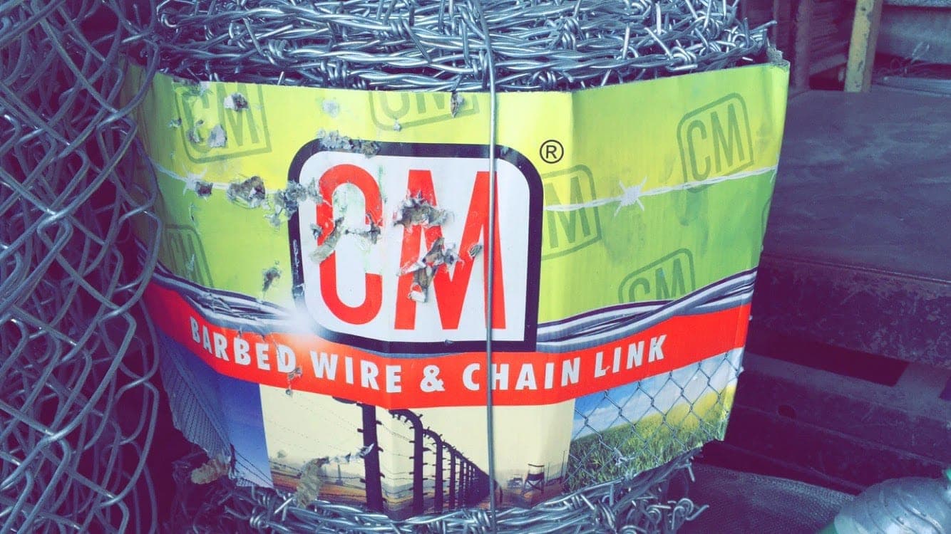 CM barbed wire and chain link label on a coil