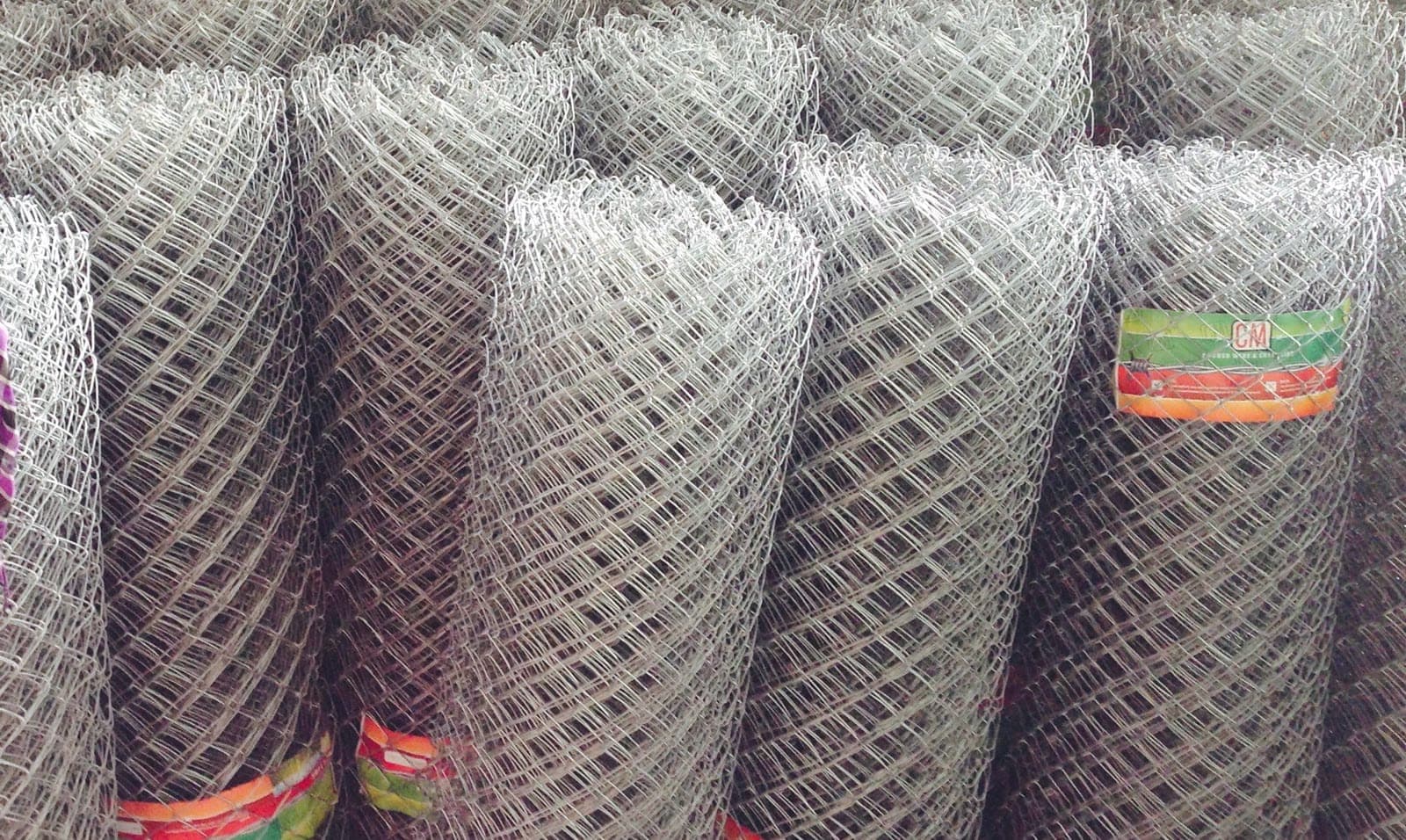 Rolls of CM chain link fencing in rows