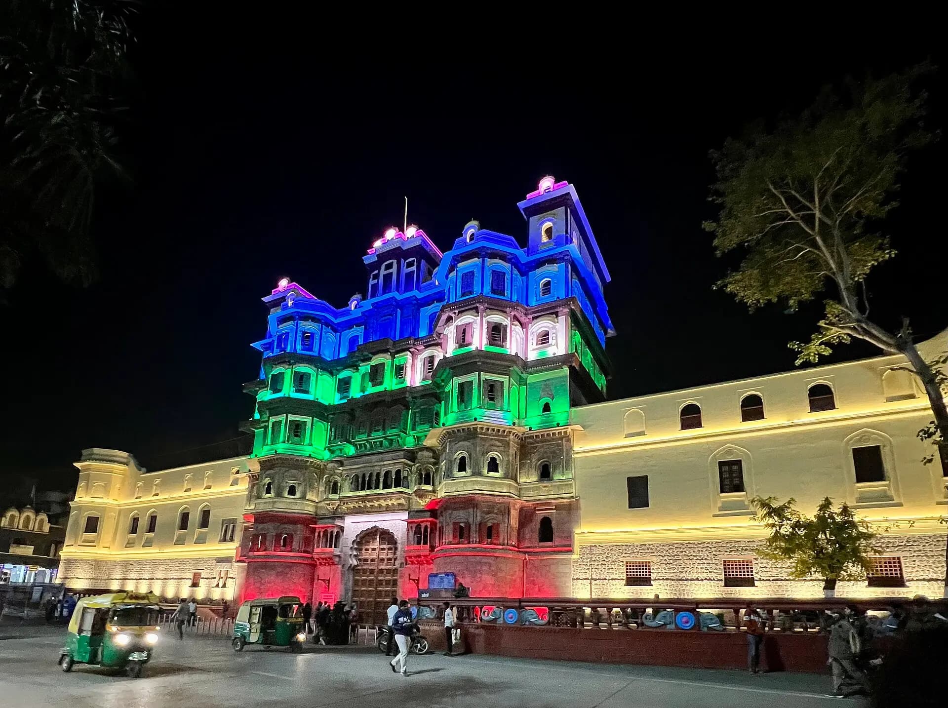 Rajwada, the old Holkar palace in the heart of Indore, lit up at night with auto-rickshaws in front
