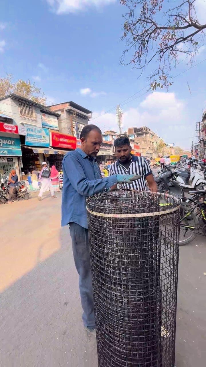 Customers checking a welded mesh roll at the counter