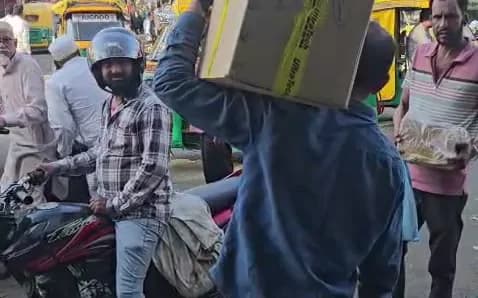 Porter carrying a boxed load through Siyaganj market