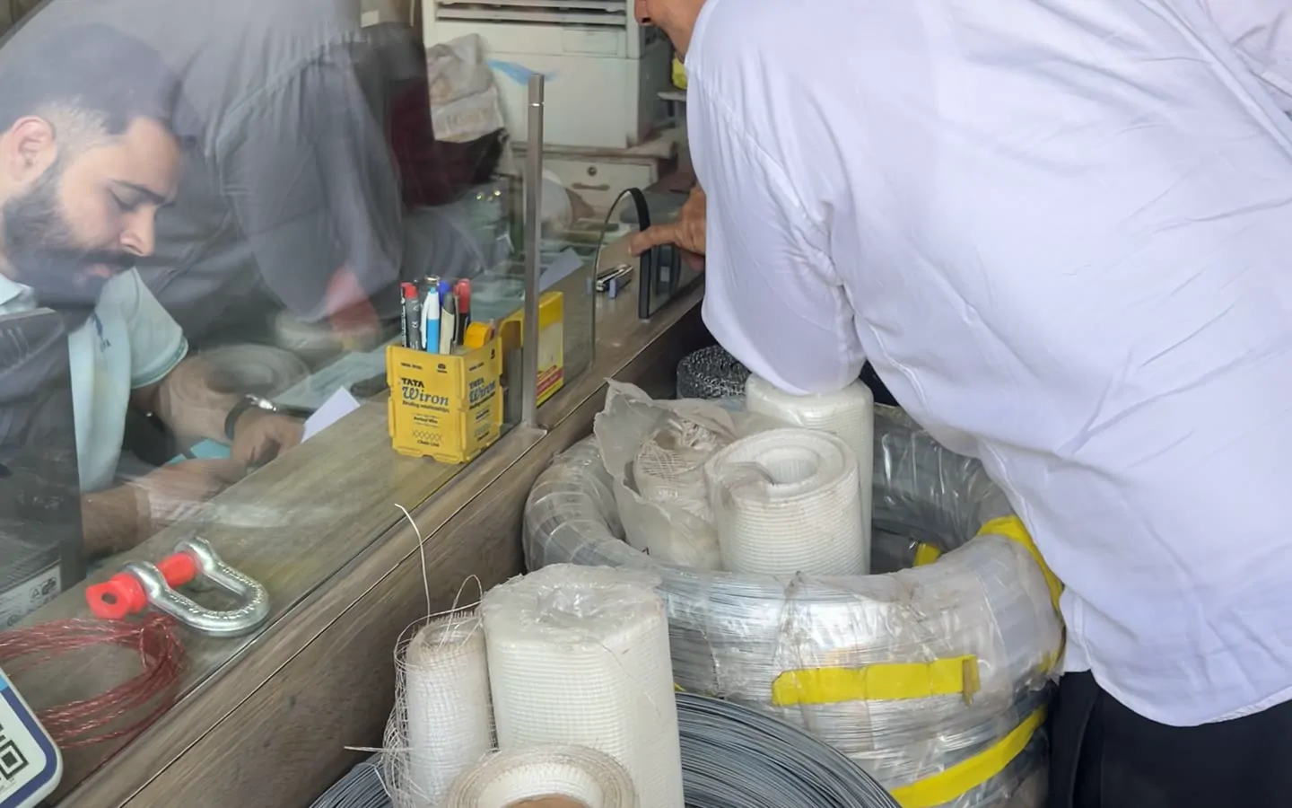 Wire and tape being weighed and packed at the counter
