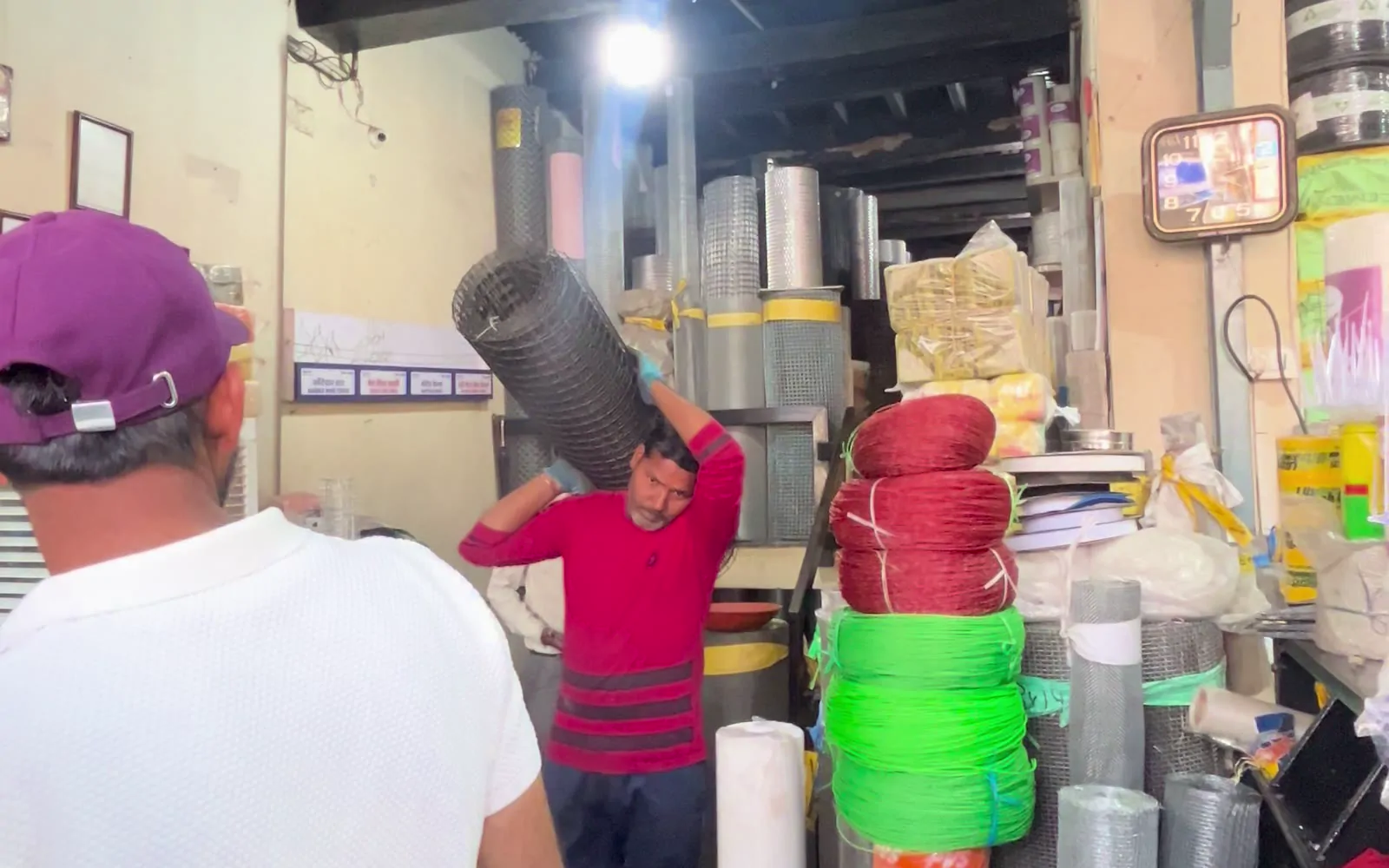 Staff carrying a mesh roll through the shop