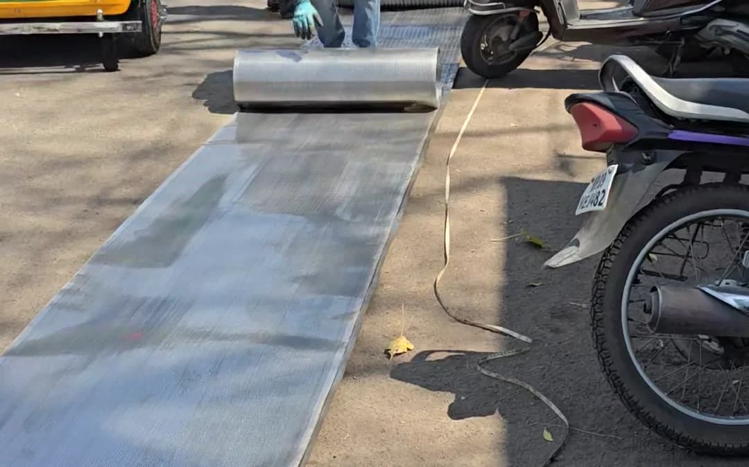 Rolling out a perforated sheet before cutting