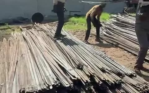 Steel rods stacked in an open yard before loading