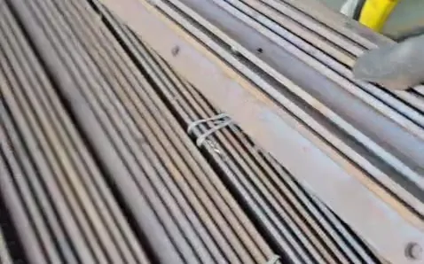 A bundle of steel bars tied and laid out on the counter table for weighing