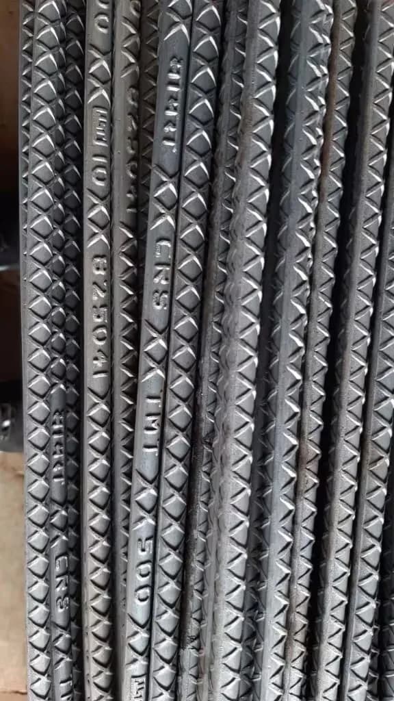 TMT bars with a ribbed surface stacked in long lengths, view 3
